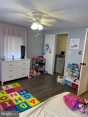 a bedroom with bed and a wooden floor