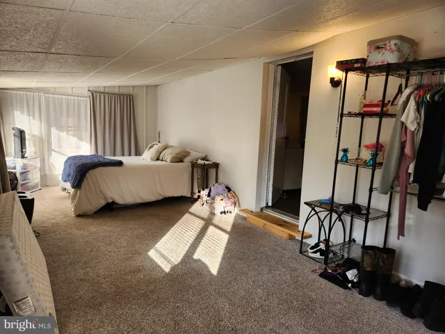 a bedroom with furniture and a window