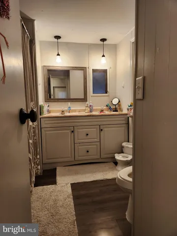 a spacious bathroom with a granite countertop sink and a mirror