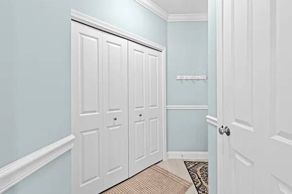 a bedroom with a bed a flat screen tv and guitar