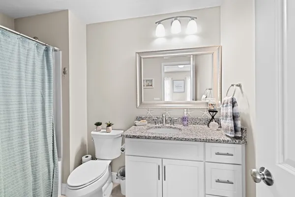 a view of a patio with furniture and a garden