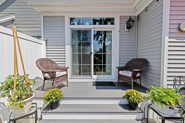 a view of a chairs and table in patio with a fire pit