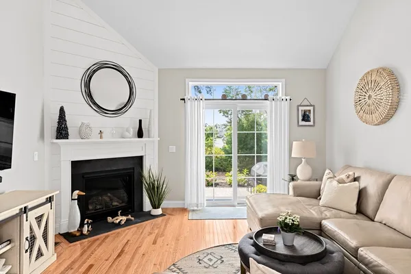 a living room with furniture a clock and a window