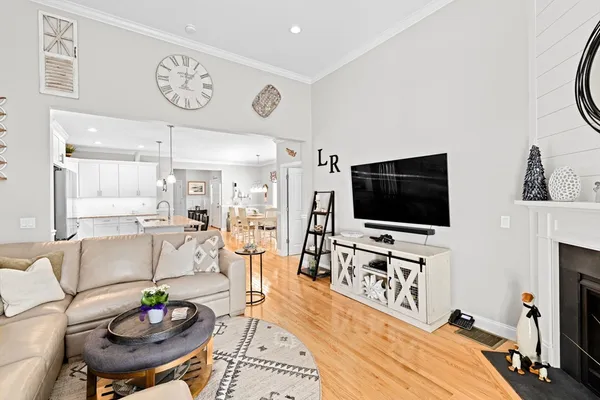 a kitchen with granite countertop a stove a sink a refrigerator a center island and cabinets