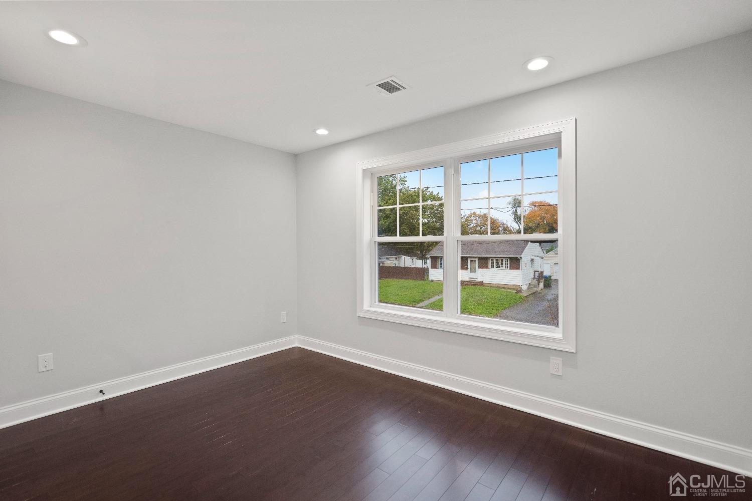 42 Wayne Street Edison, NJ 08817 - Photo 12 of 22 an empty room with wooden floor and windows