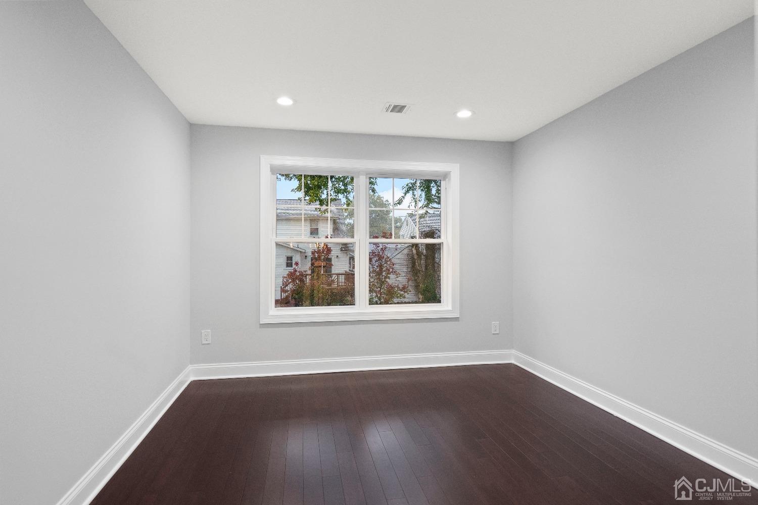42 Wayne Street Edison, NJ 08817 - Photo 16 of 22 an empty room with wooden floor and windows