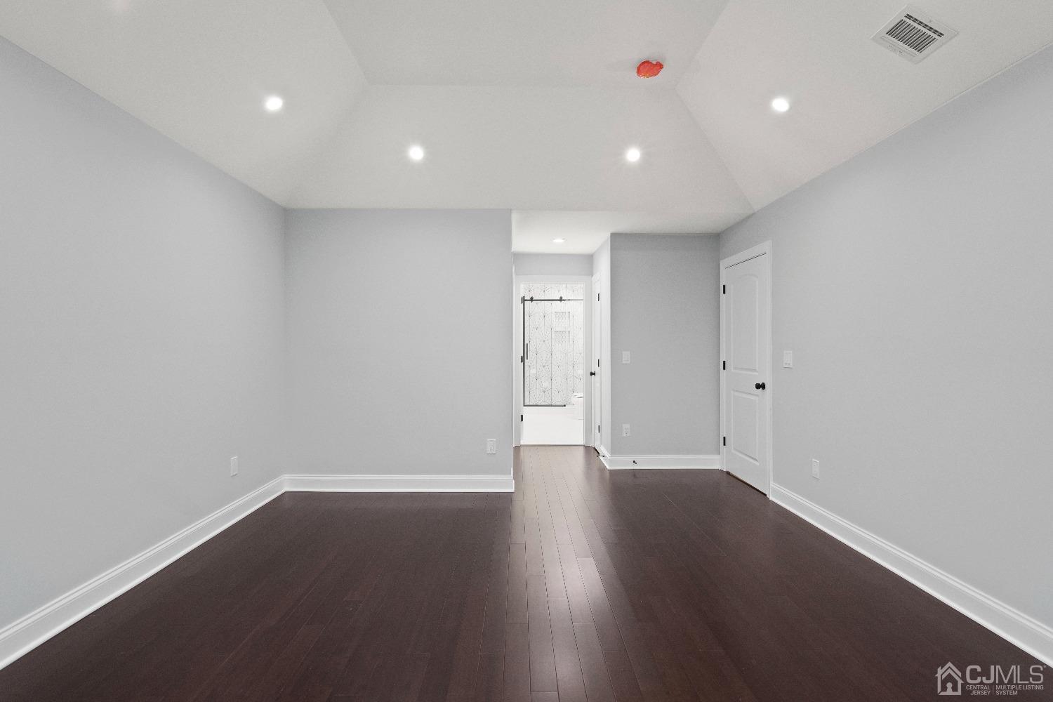 42 Wayne Street Edison, NJ 08817 - Photo 18 of 22 an empty room with wooden floor and windows