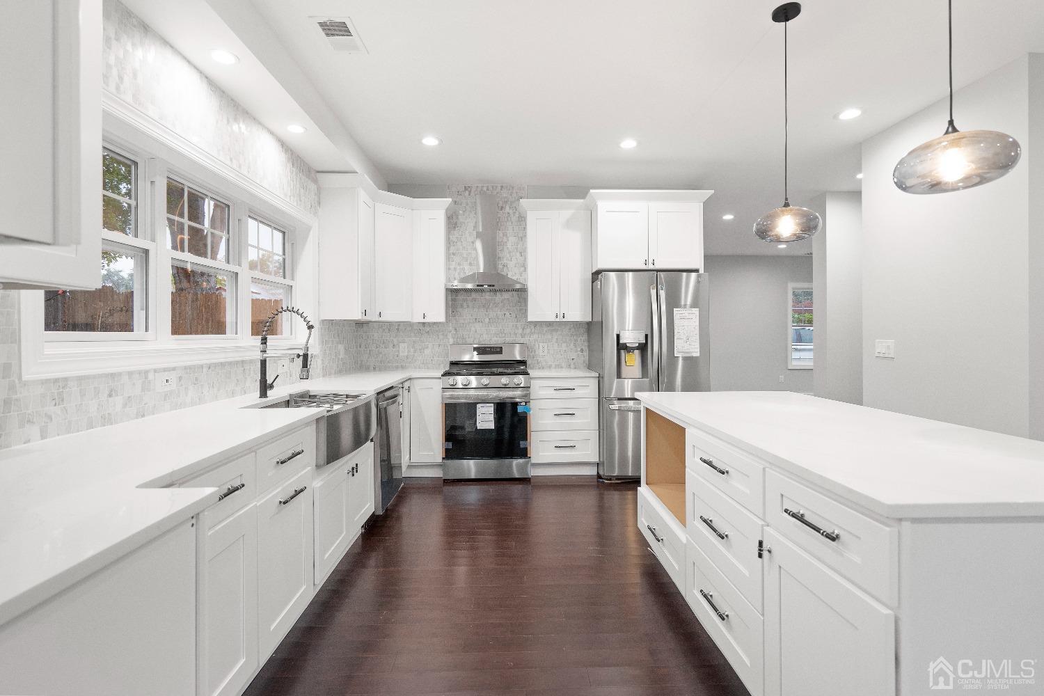 42 Wayne Street Edison, NJ 08817 - Photo 5 of 22 a kitchen with white cabinets and stainless steel appliances