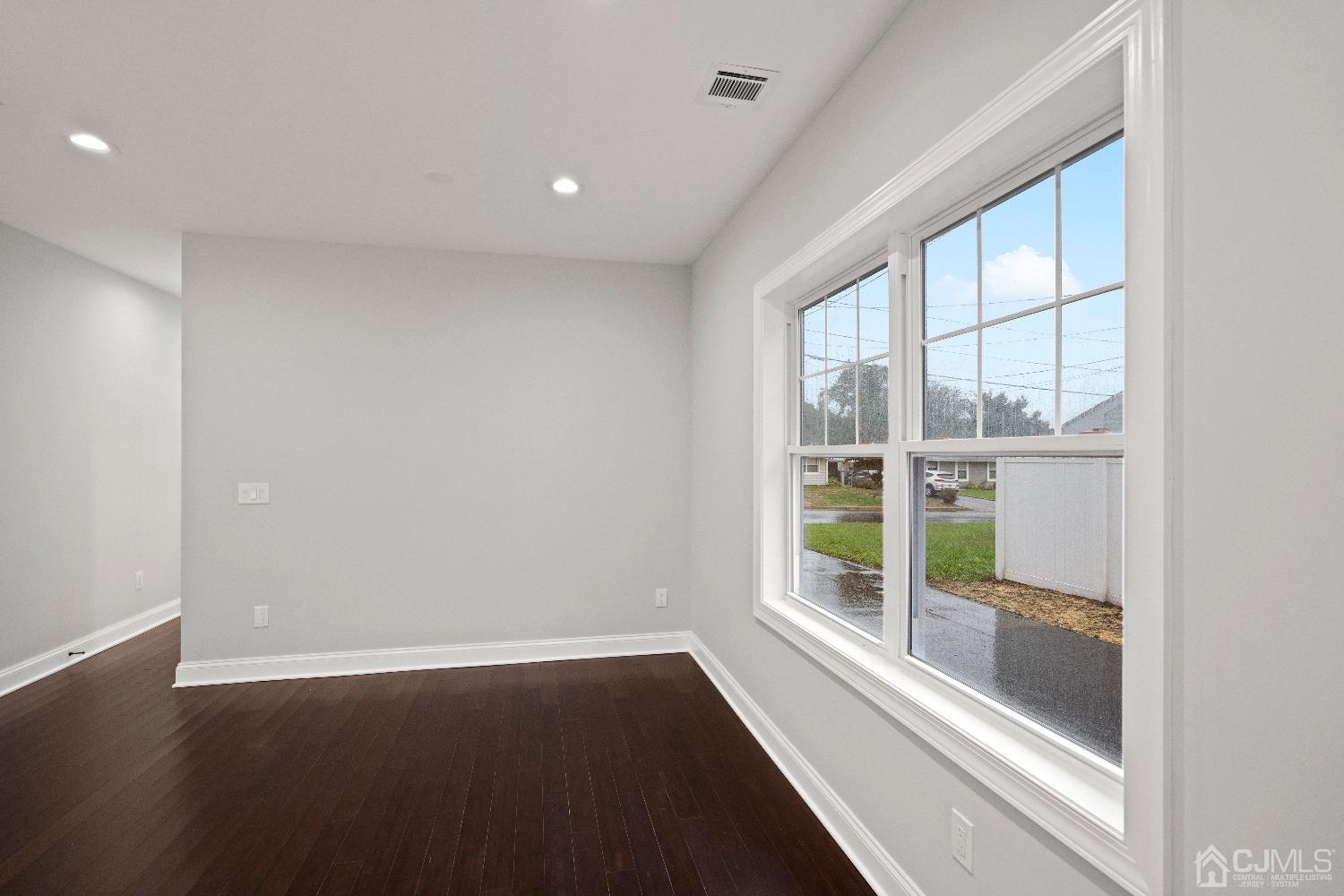 42 Wayne Street Edison, NJ 08817 - Photo 7 of 22 an empty room with wooden floor and windows