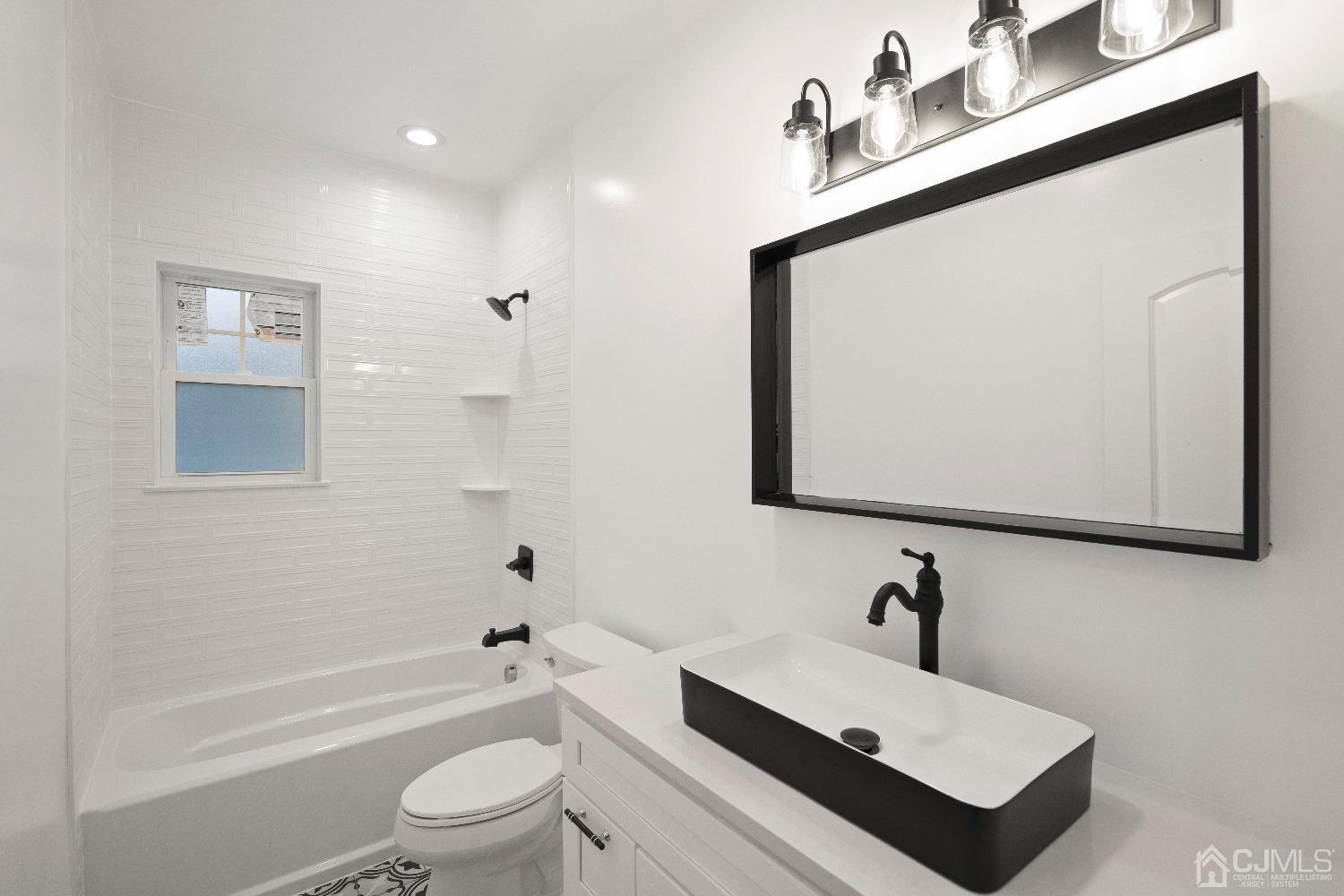 42 Wayne Street Edison, NJ 08817 - Photo 8 of 22 a bathroom with a sink a toilet and shower