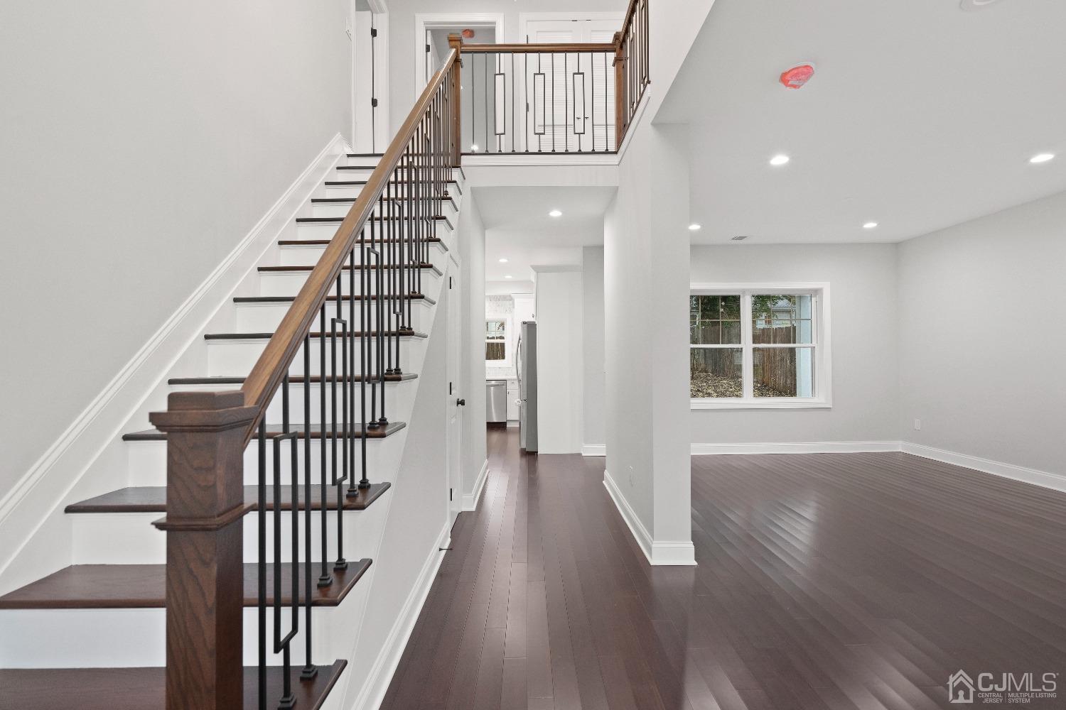 42 Wayne Street Edison, NJ 08817 - Photo 10 of 22 a view of a hallway with wooden floor windows and stairs