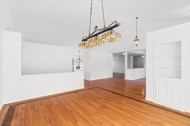 an empty room with a fireplace and fan