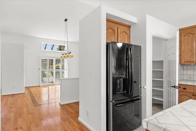 an empty room with windows and ceiling fan