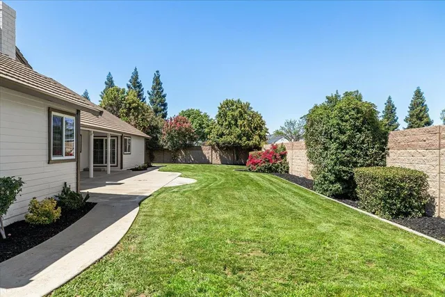 a front view of a house with a garden and yard