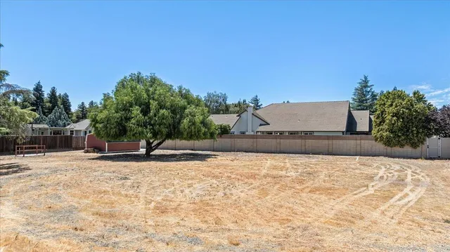 a view of a patio with table and chairs with wooden floor and fence