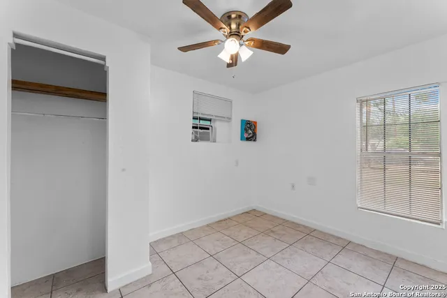 a view of a livingroom with a ceiling fan and window