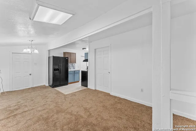 a view of a kitchen with refrigerator cabinet and a sink