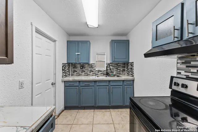 a kitchen with a stove and a sink