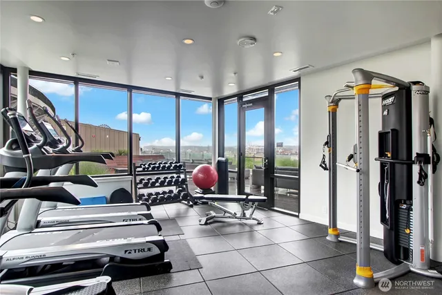 a gym room with lots of gym equipment