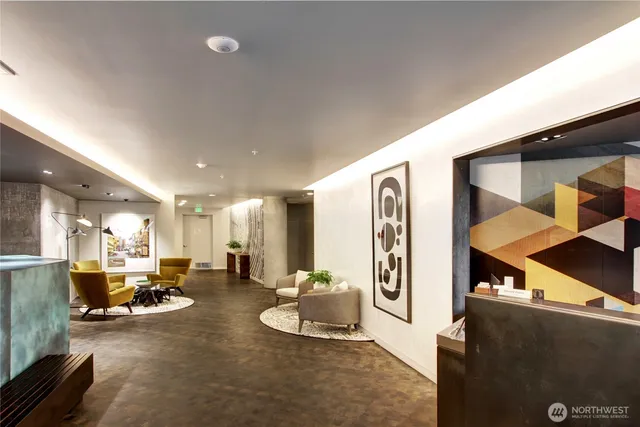 a lobby with furniture and a large mirror