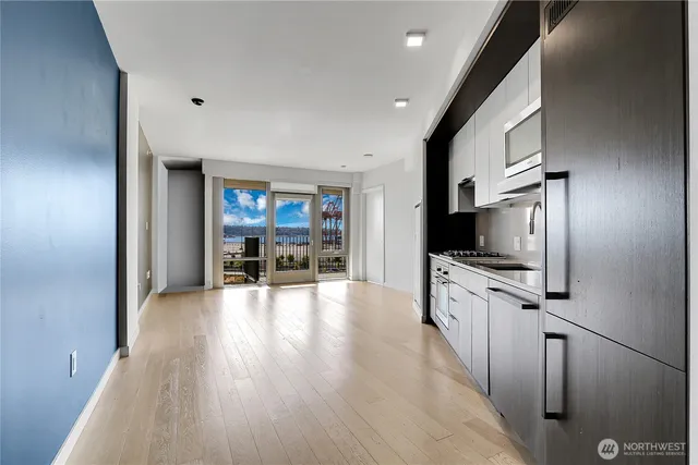a view of a kitchen with furniture flat screen tv and staircase