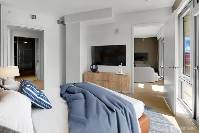 a hotel room with a bed and a flat screen tv