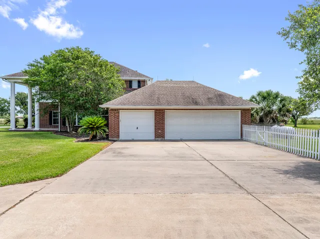 a kitchen with stainless steel appliances granite countertop a stove a sink dishwasher a refrigerator and cabinets with wooden floor