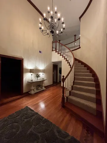 a bedroom with a large bed and a wooden floor