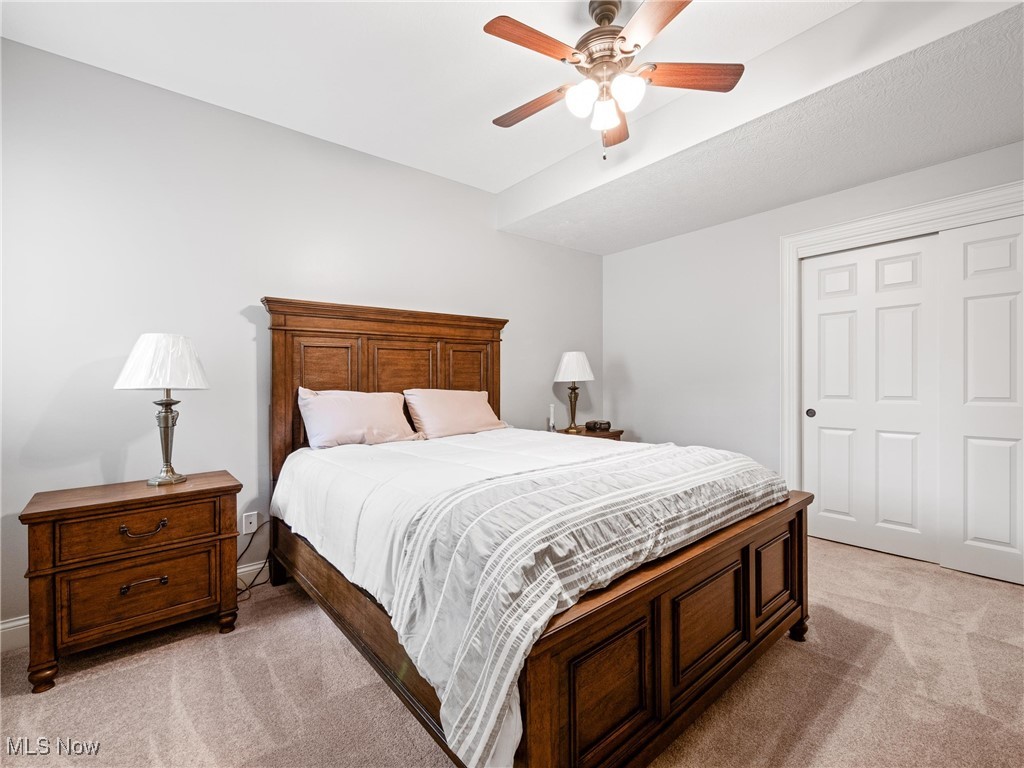 5349 Slater Ridge Westerville, OH 43082 - Photo 35 of 50 Bedroom featuring light carpet, a closet, and a ceiling fan