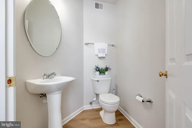 a bathroom with a sink toilet and a mirror