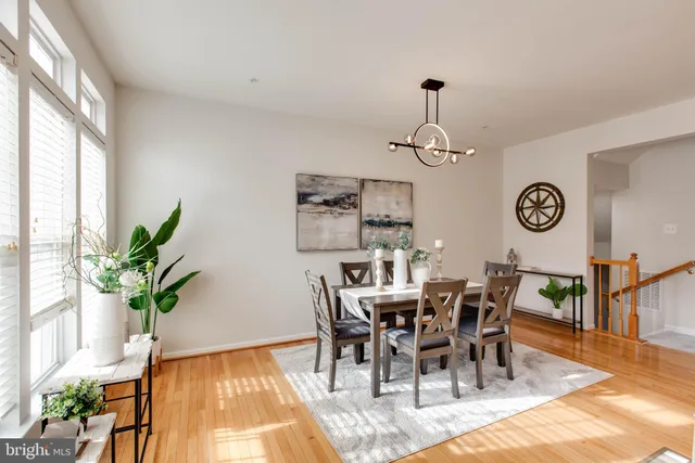 a very nice looking dining room with furniture window and wooden floor