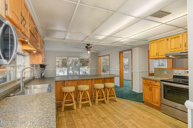a large kitchen with a table and chairs in it