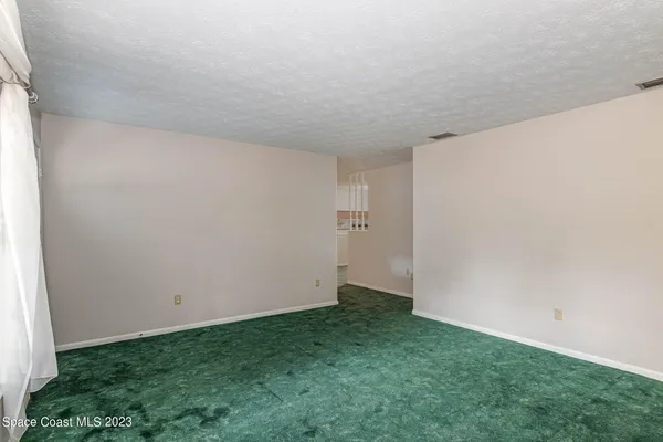 an empty room with kitchen