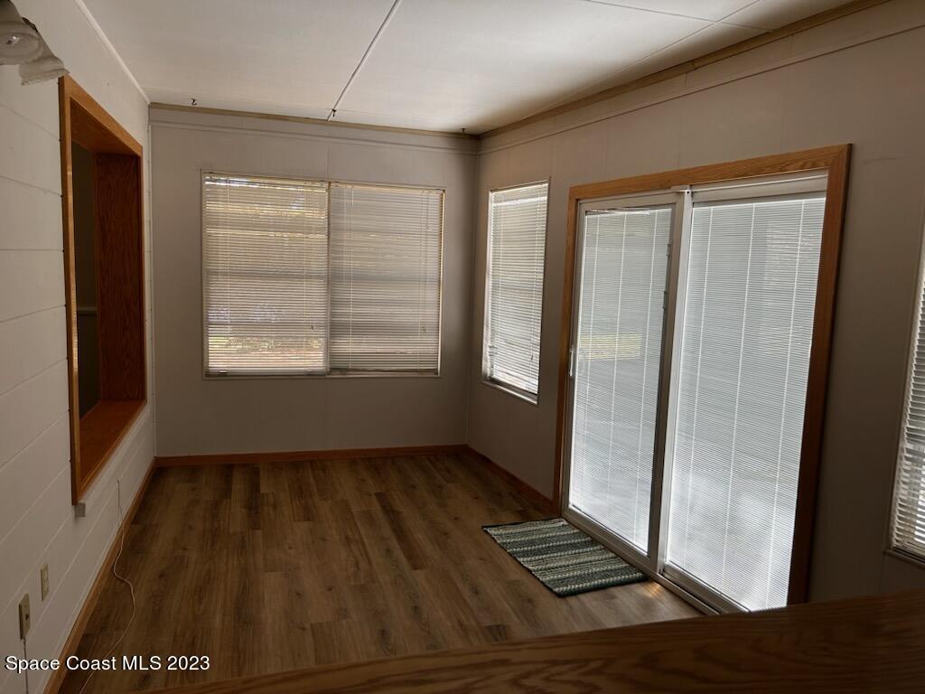 8203 Lake Echo Ridge Drive Melrose, FL 32666 - Photo 21 of 31 an empty room with wooden floor and windows