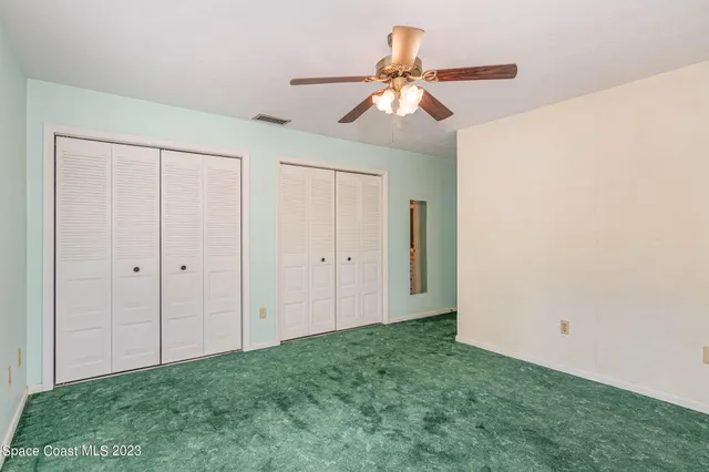 a view of room with hardwood floor and ceiling fan