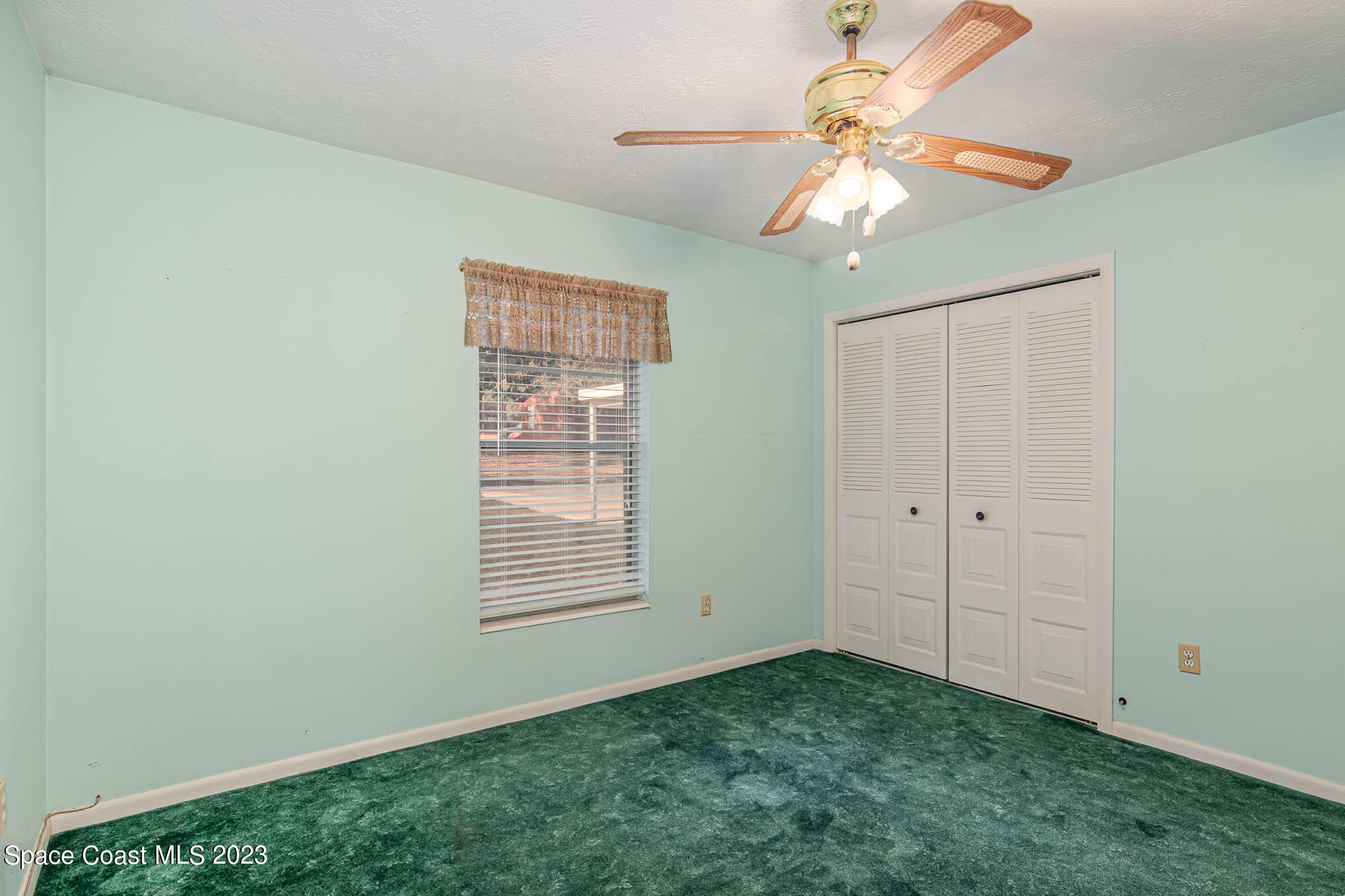 8203 Lake Echo Ridge Drive Melrose, FL 32666 - Photo 26 of 31 a view of an empty room with window chandelier fan