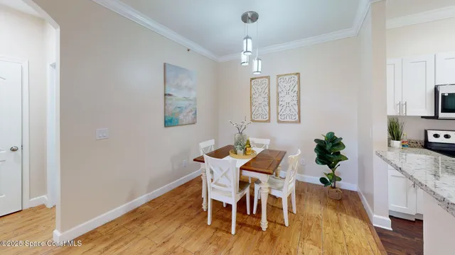 a view of a dining room with furniture and wooden floor
