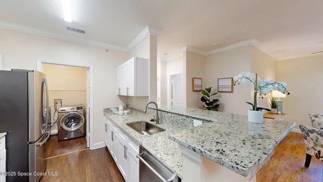 a kitchen that has a sink and a stove in it