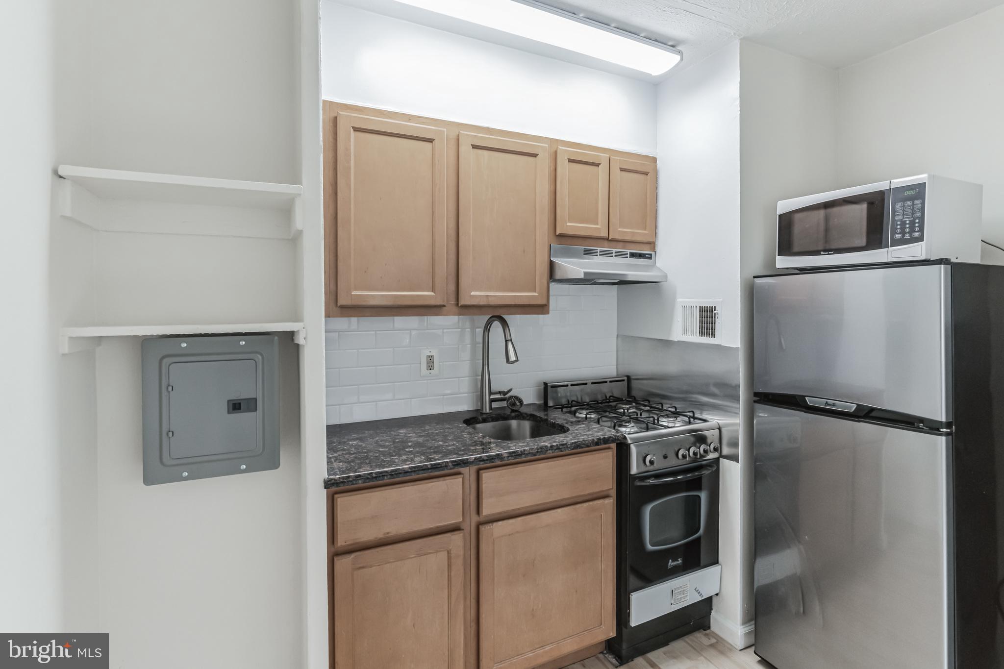 2101 Chestnut Street, Unit 1102 Philadelphia, PA 19103 - Photo 12 of 17 a kitchen with a refrigerator stove and microwave
