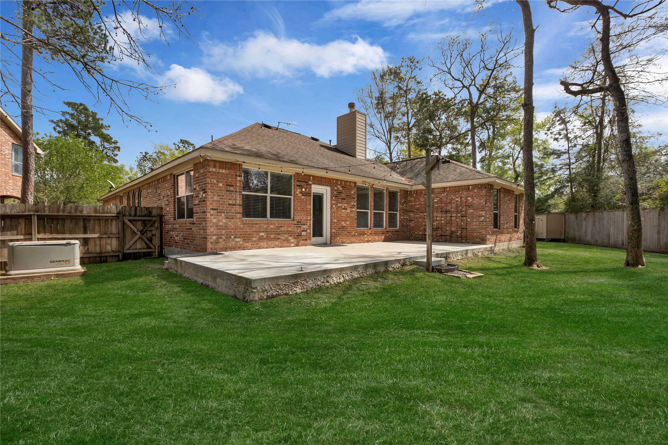 27 Planchard Court Spring, TX 77382 - Photo 15 of 16 a view of a house with a backyard and a patio