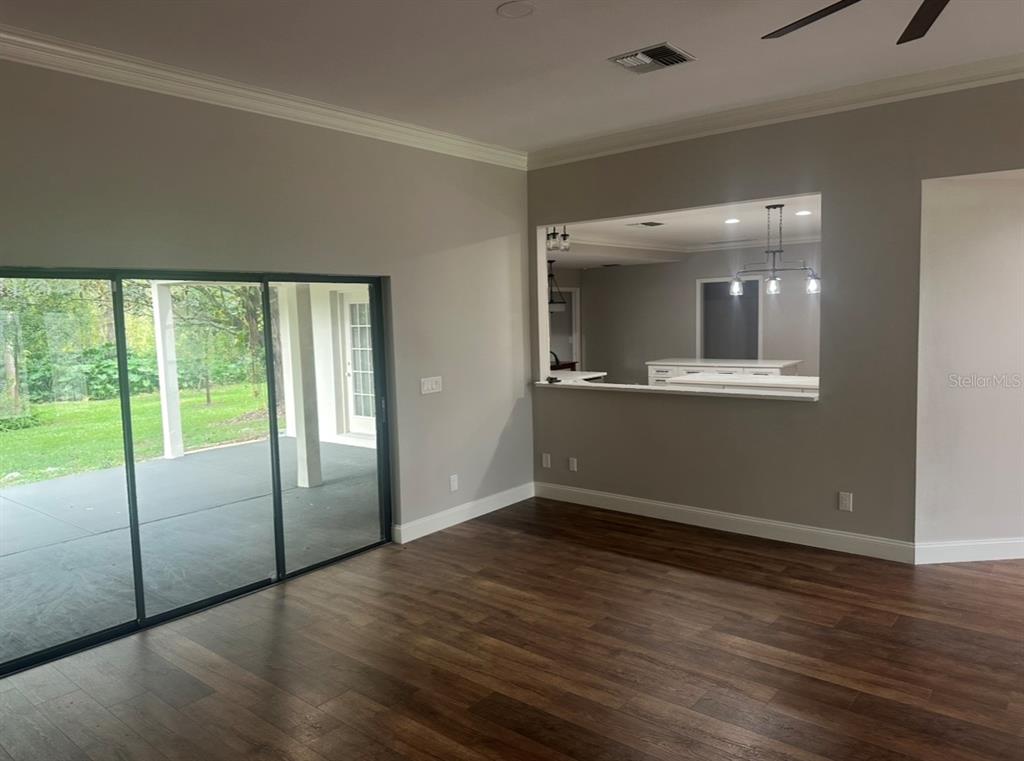 18306 Pleasant Ridge Place Lutz, FL 33548 - Photo 8 of 8 an empty room with wooden floor and windows