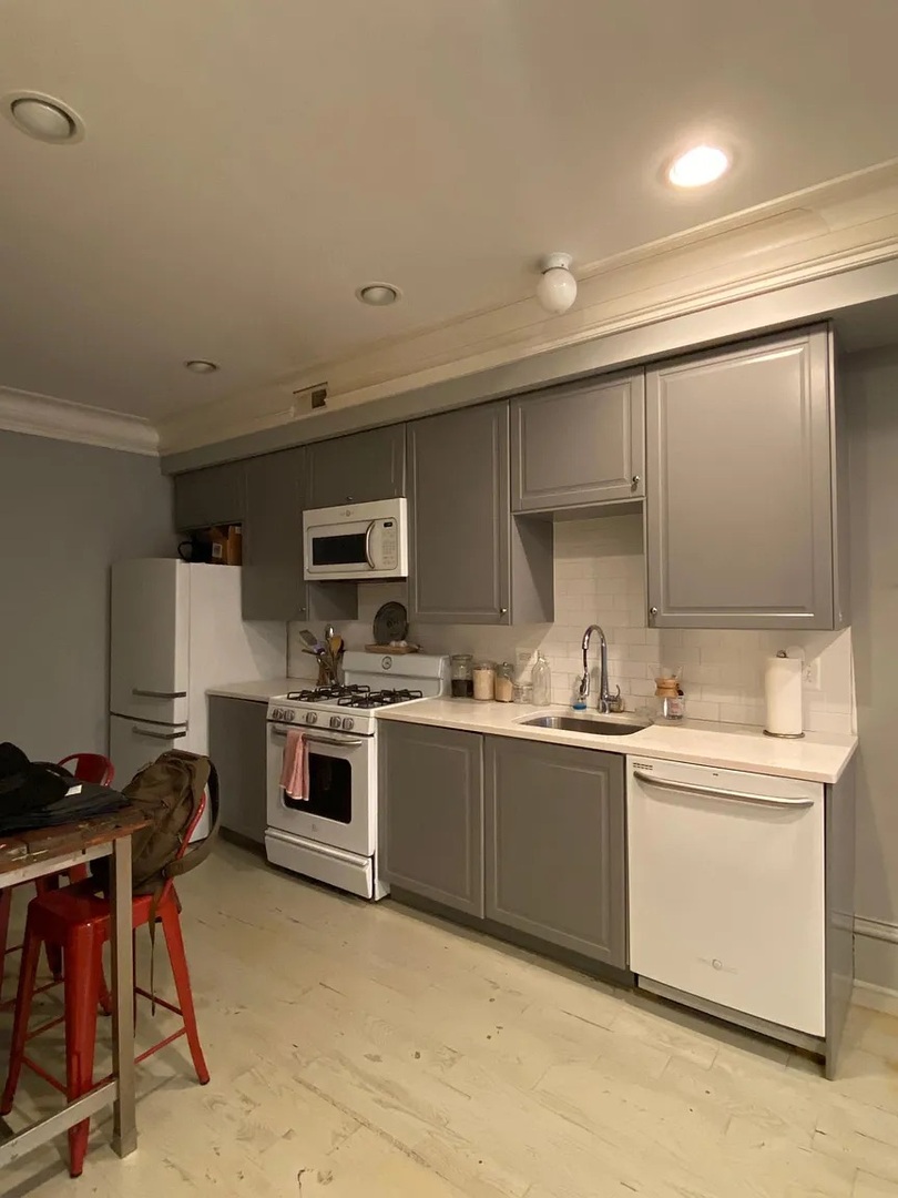 2157 West Adams Street, Unit 1 Chicago, IL 60612 - Photo 2 of 10 a kitchen with stainless steel appliances granite countertop a stove and a sink