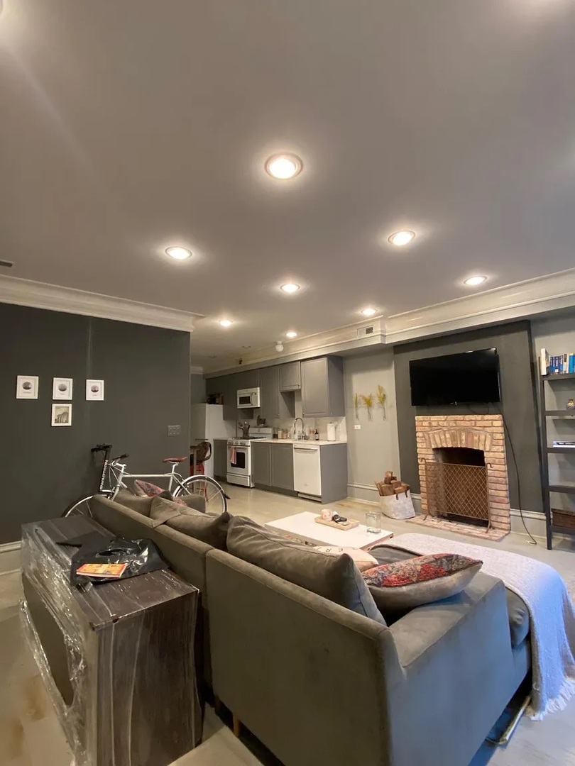 2157 West Adams Street, Unit 1 Chicago, IL 60612 - Photo 7 of 10 a living room with furniture a flat screen tv and kitchen view