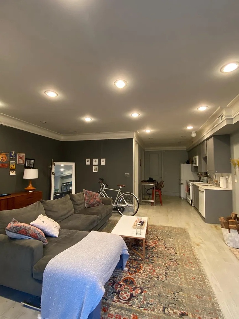 2157 West Adams Street, Unit 1 Chicago, IL 60612 - Photo 9 of 10 a living room with furniture a couch and kitchen view