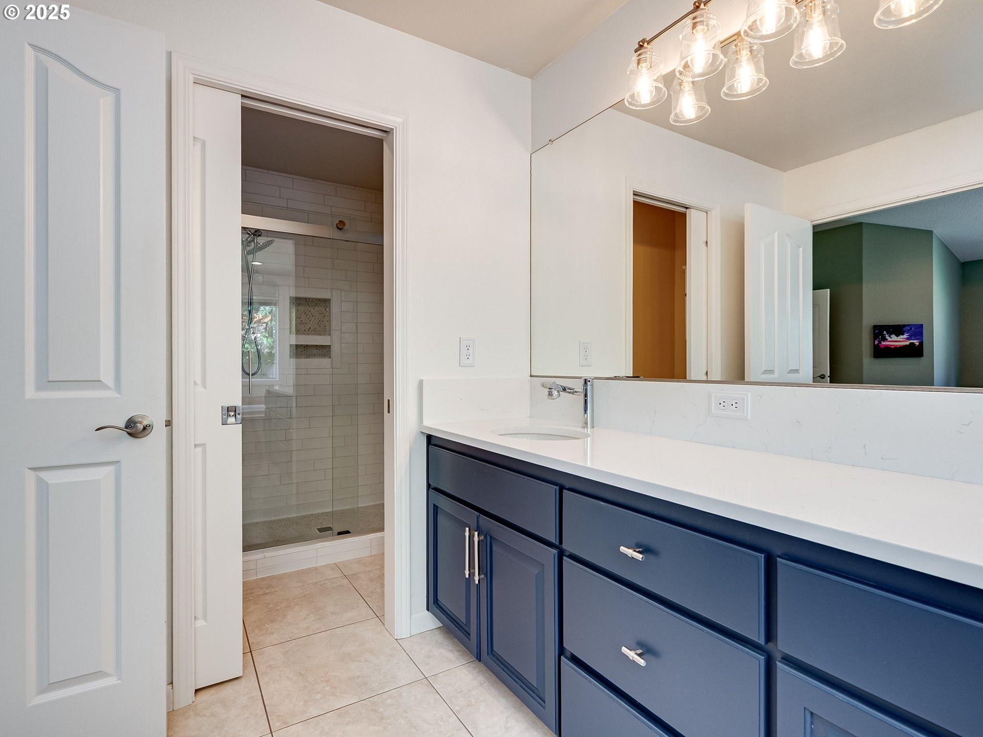 2745 Northwest 29th Avenue Camas, WA 98607 - Photo 16 of 29 a spacious bathroom with a granite countertop sink a mirror and a shower