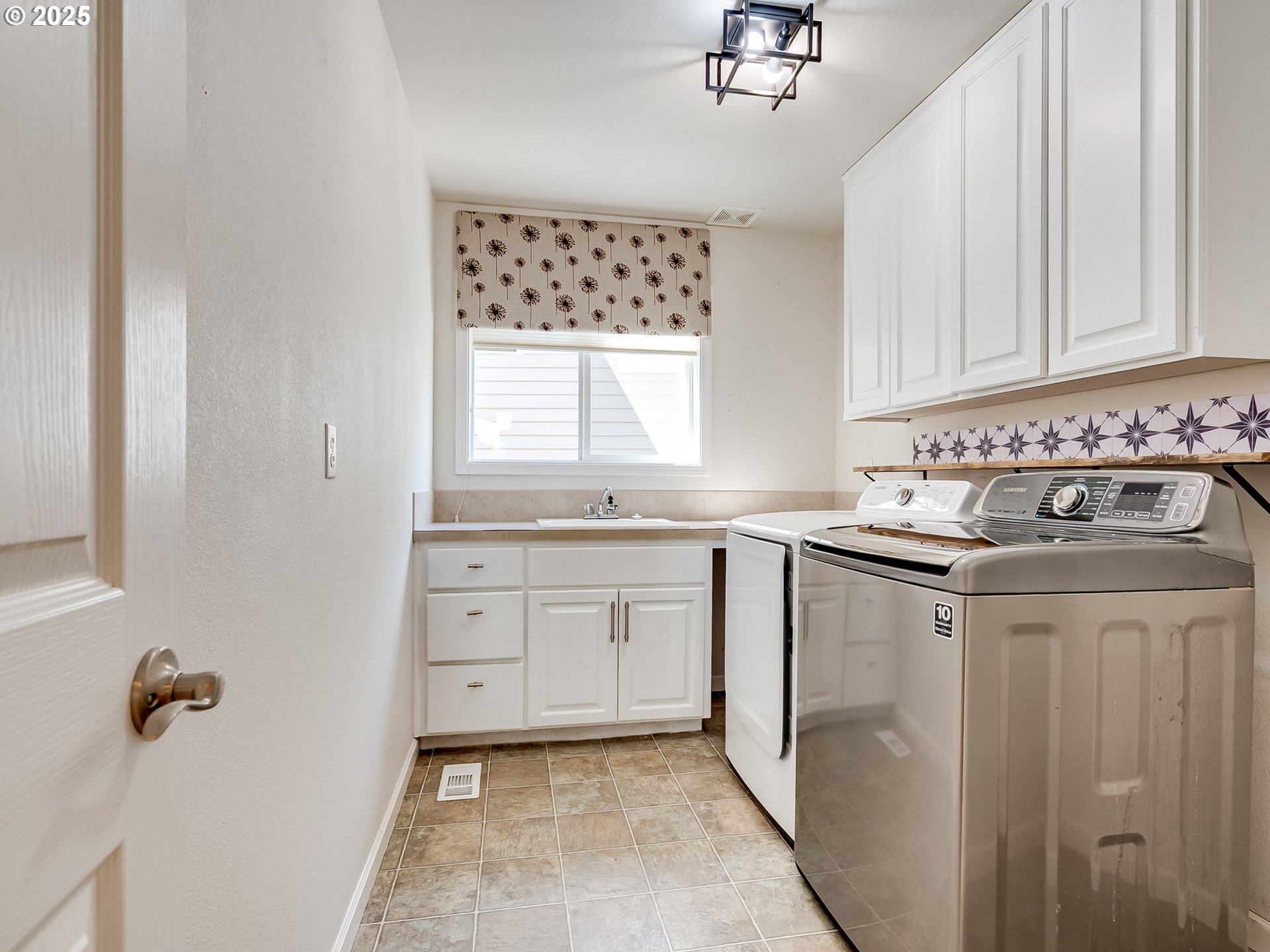 2745 Northwest 29th Avenue Camas, WA 98607 - Photo 25 of 29 a kitchen with granite countertop white cabinets and white appliances
