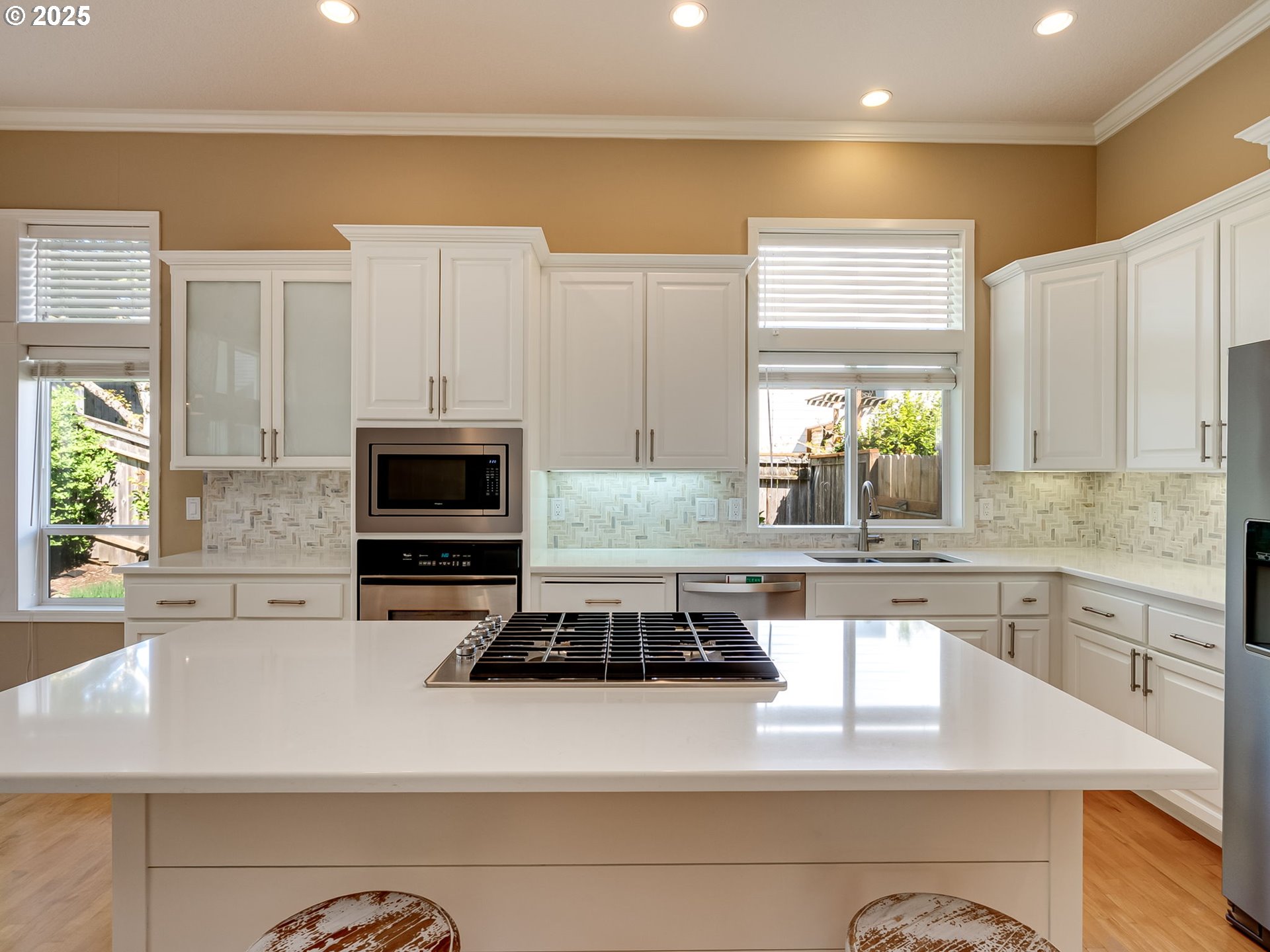 2745 Northwest 29th Avenue Camas, WA 98607 - Photo 6 of 29 a kitchen with kitchen island granite countertop a stove top oven a sink a counter space and cabinets