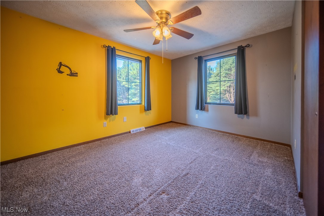 3459 Laubert Road Atwater, OH 44201 - Photo 20 of 39 Empty room with carpet, a textured ceiling, and a ceiling fan