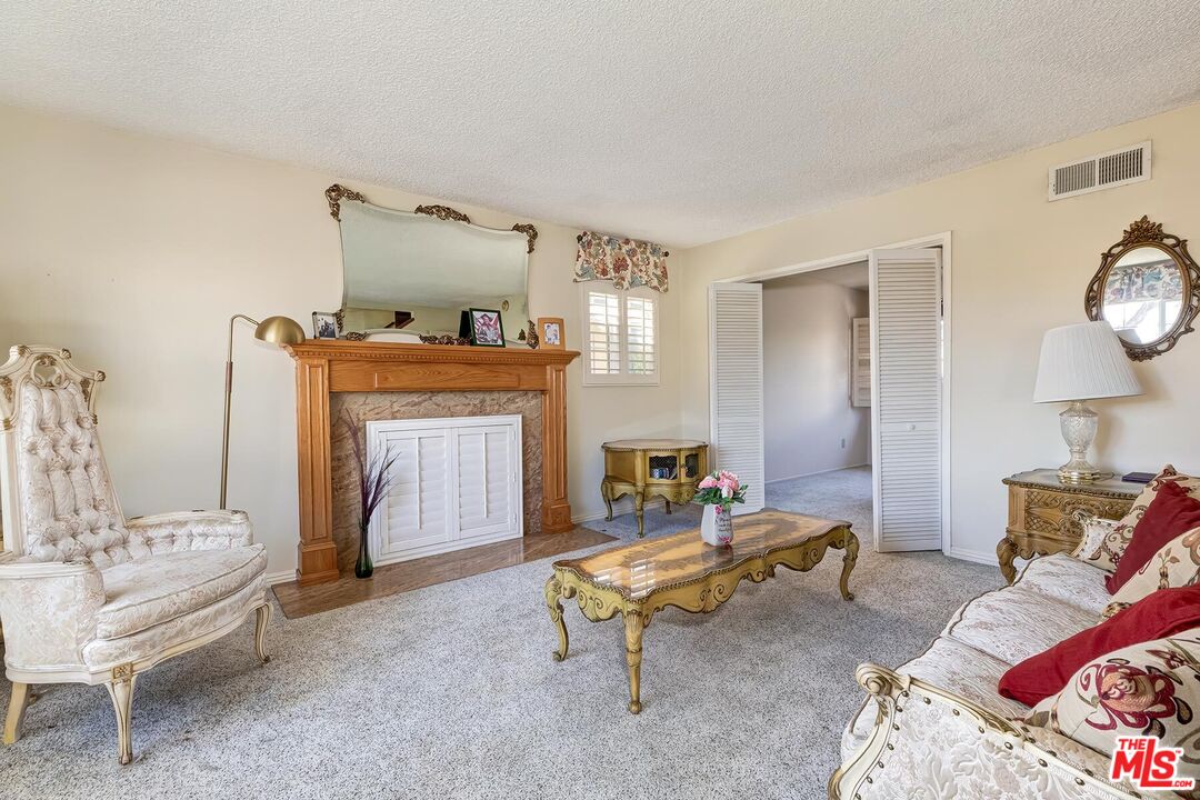 1657 East 218th Street Carson, CA 90745 - Photo 11 of 24 a living room with furniture and a fireplace