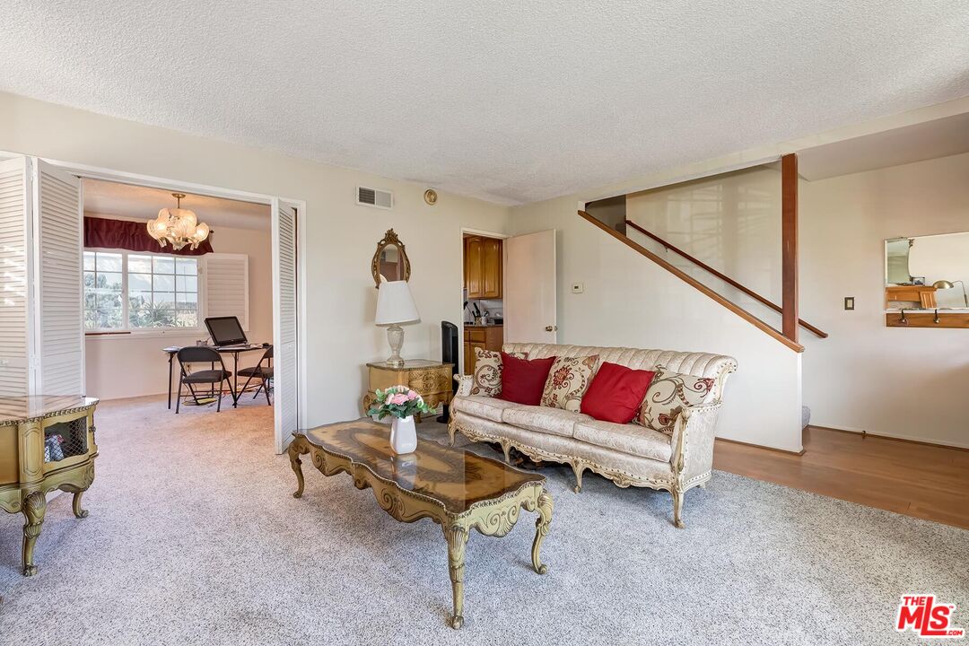 1657 East 218th Street Carson, CA 90745 - Photo 12 of 24 a living room with furniture and a floor to ceiling window